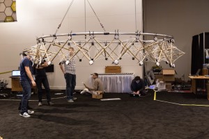 Autodesk employees work on the first steps of the Hive at Autodesk University in early December. The tensegrity structure was created by robot-human collaboration.